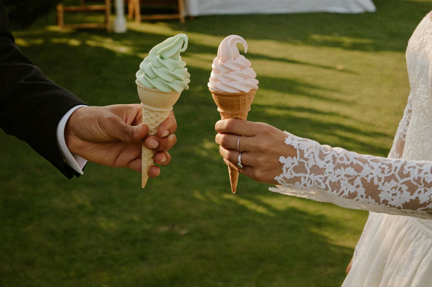 Bride and groom holding pastel soft-serve cones at their wedding reception